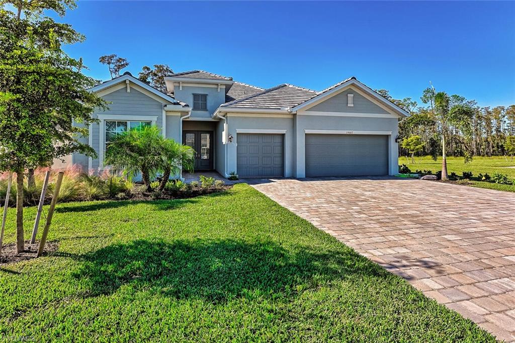 a front view of a house with a yard and garage