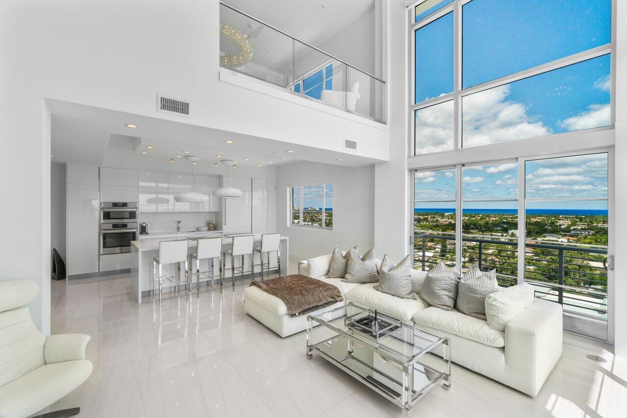 a living room with furniture and large windows