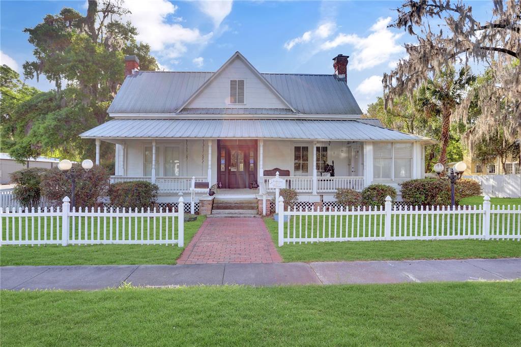 a front view of a house with a garden and plants