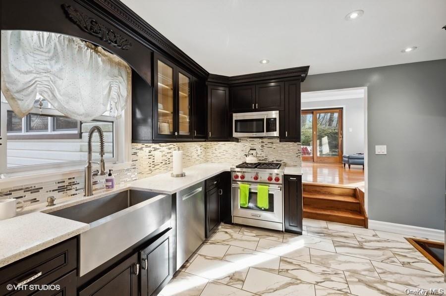 a kitchen with a sink stove and microwave