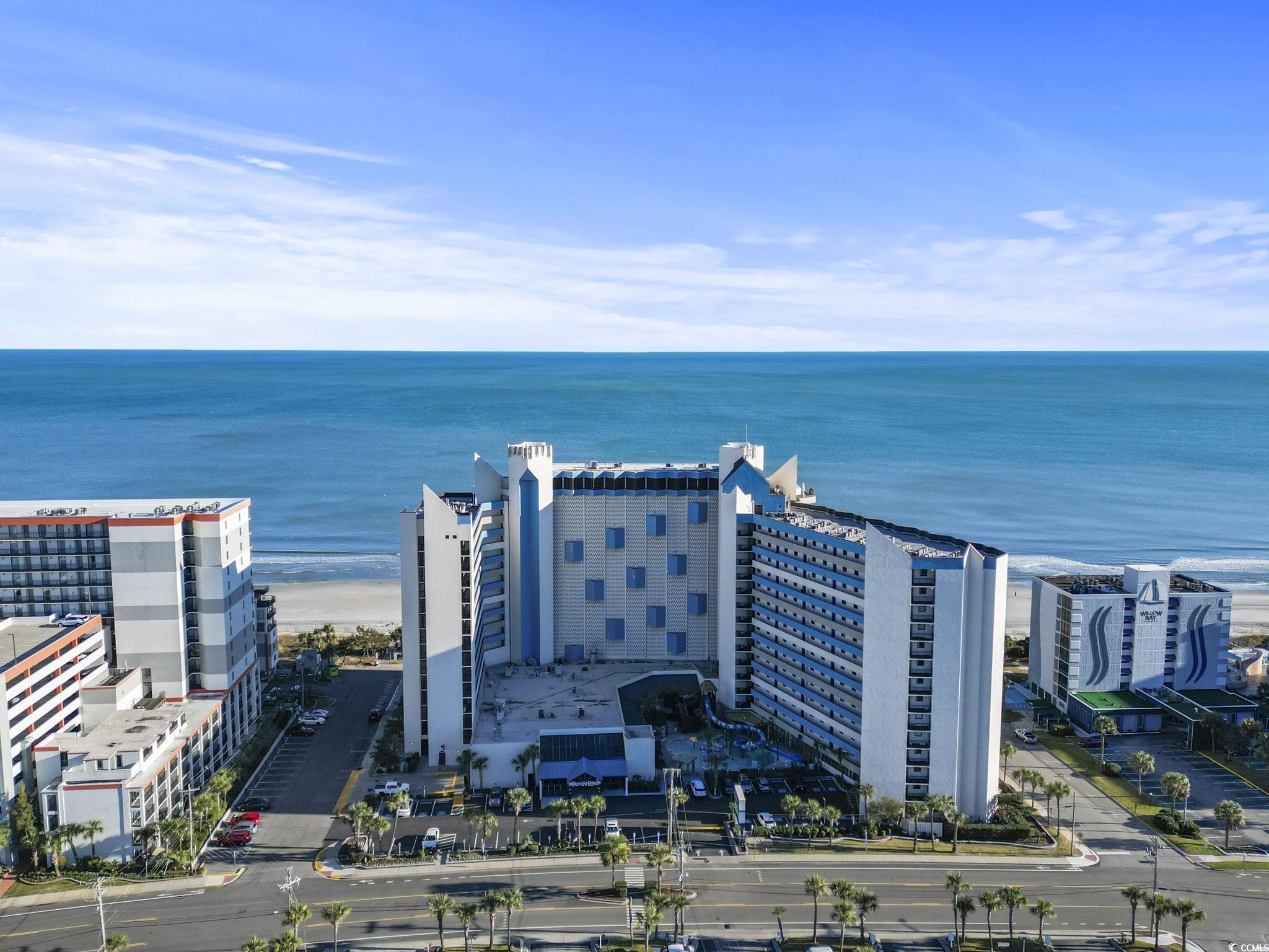 Birds eye view of property with a water view