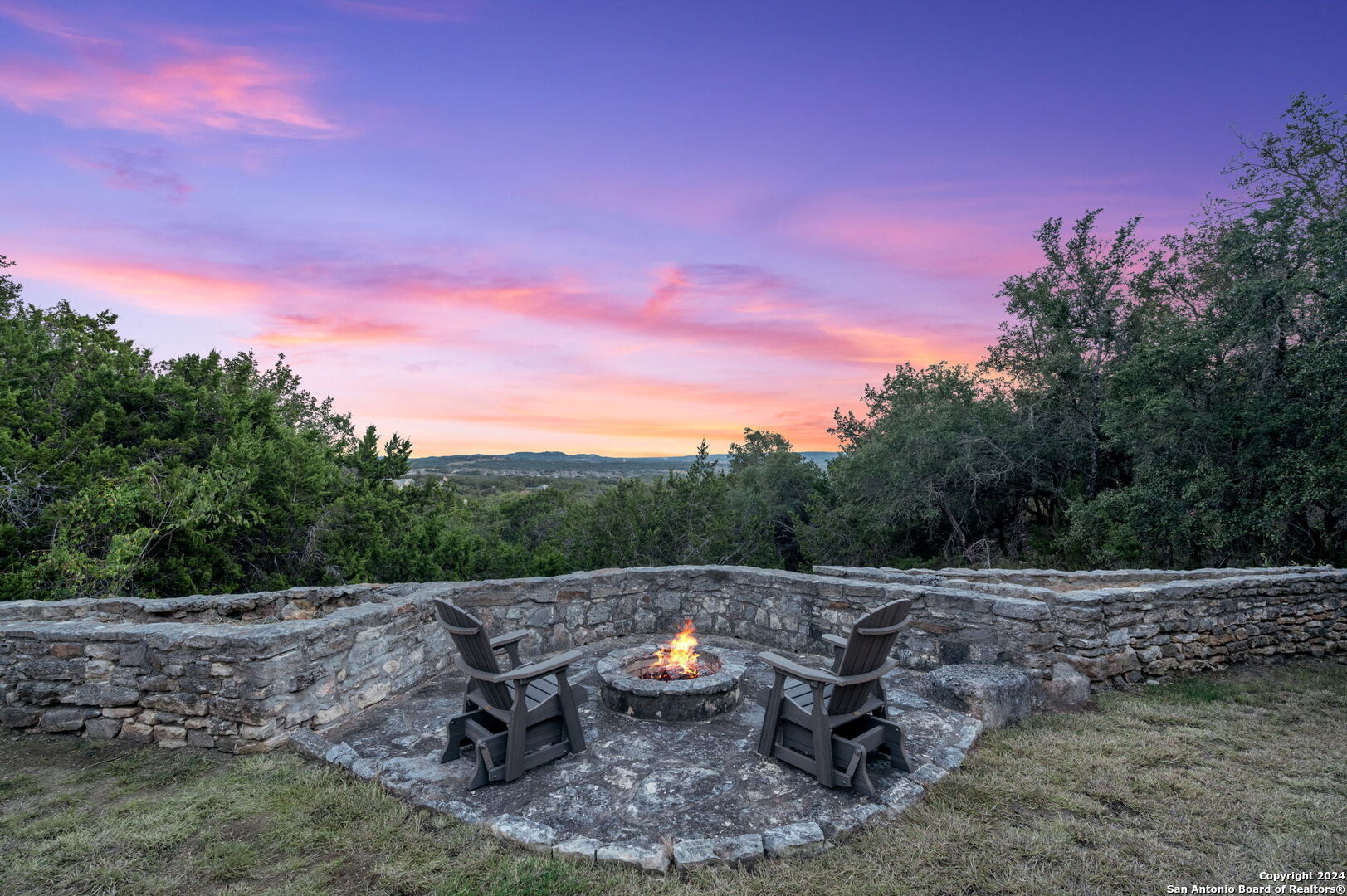 a view of a backyard with sitting area