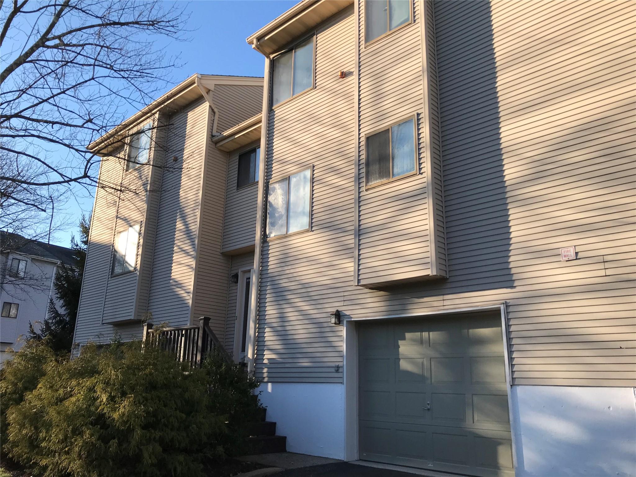 View of side of home with a garage