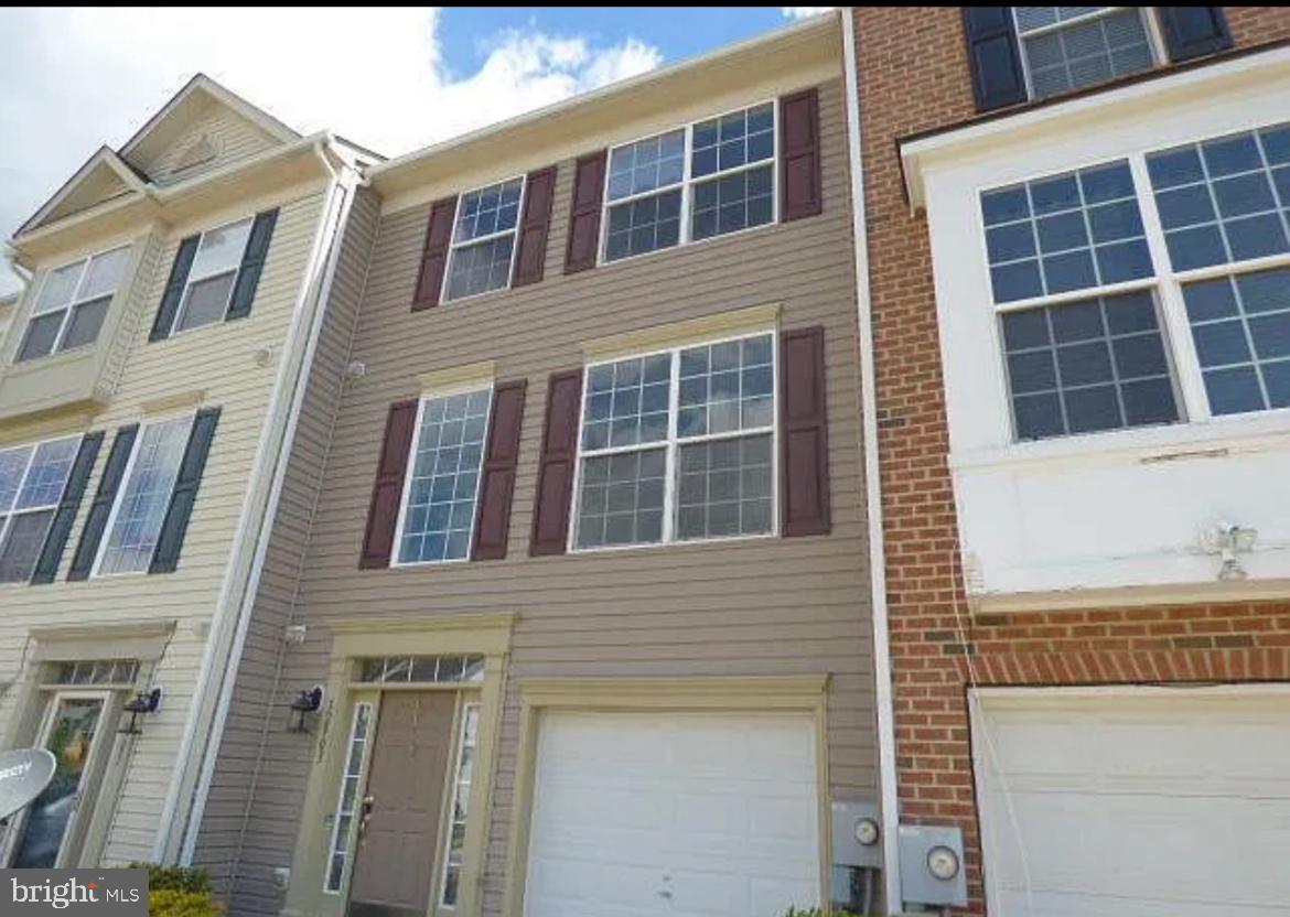 a view of a brick building next to a yard