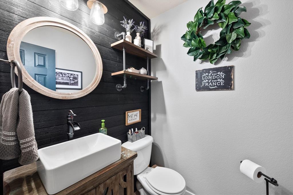 a bathroom with a toilet a sink and mirror