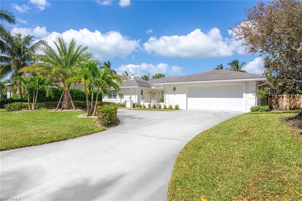 a view of a house with palm trees