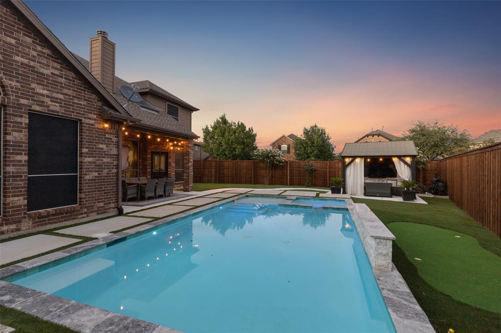 a view of a house with swimming pool and sitting area