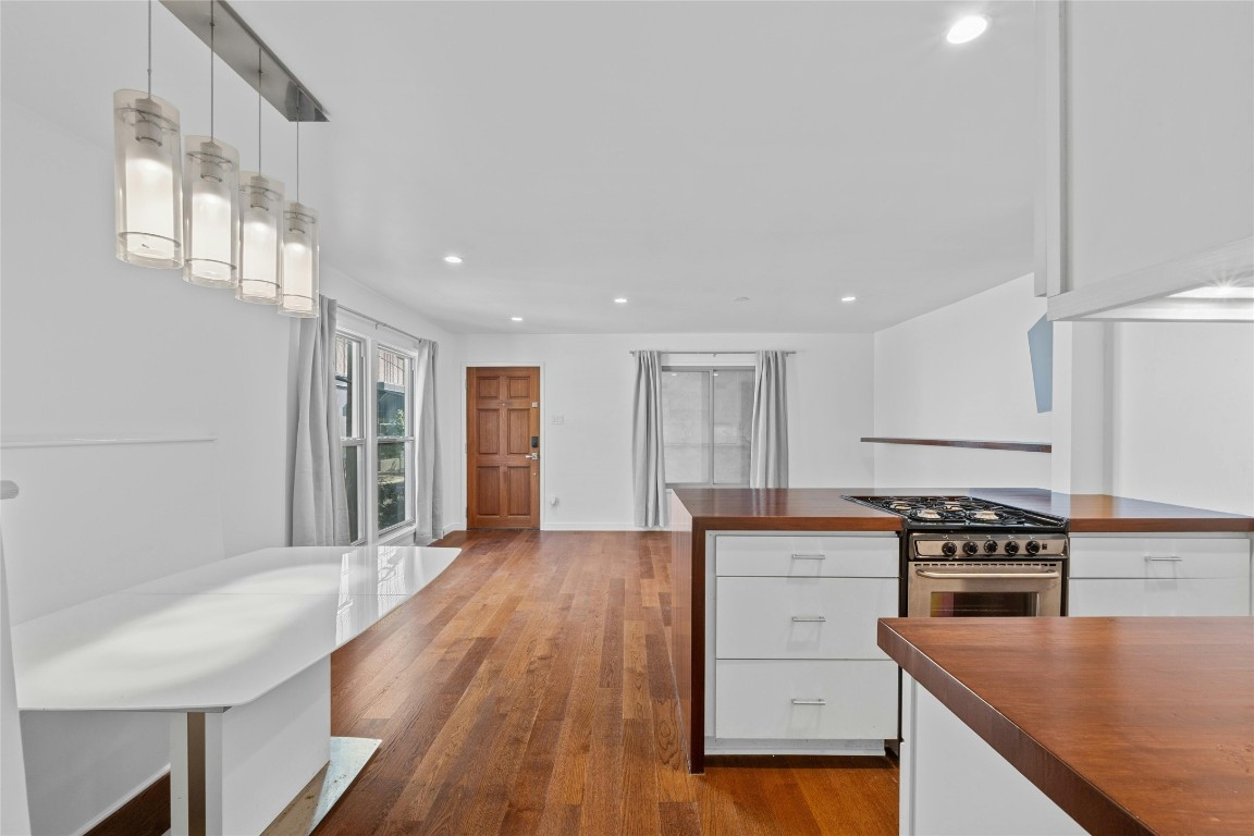 a kitchen with wooden floor and a sink