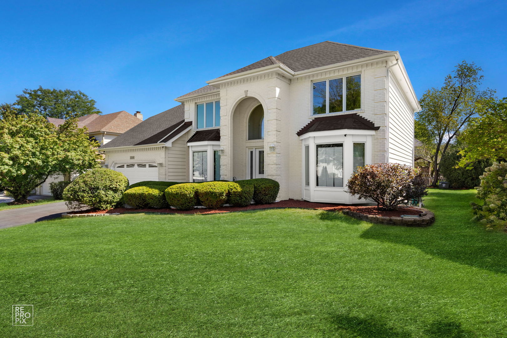 a front view of a house with a garden