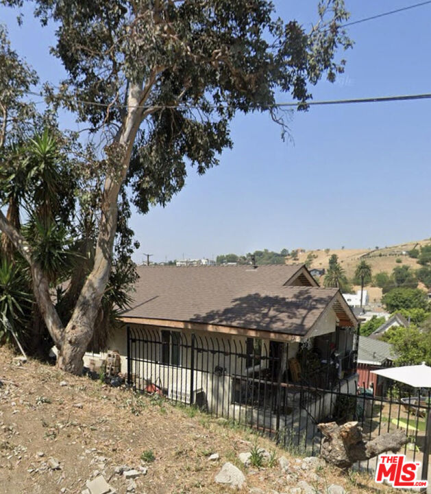 a view of a house with a yard covered with snow in the background