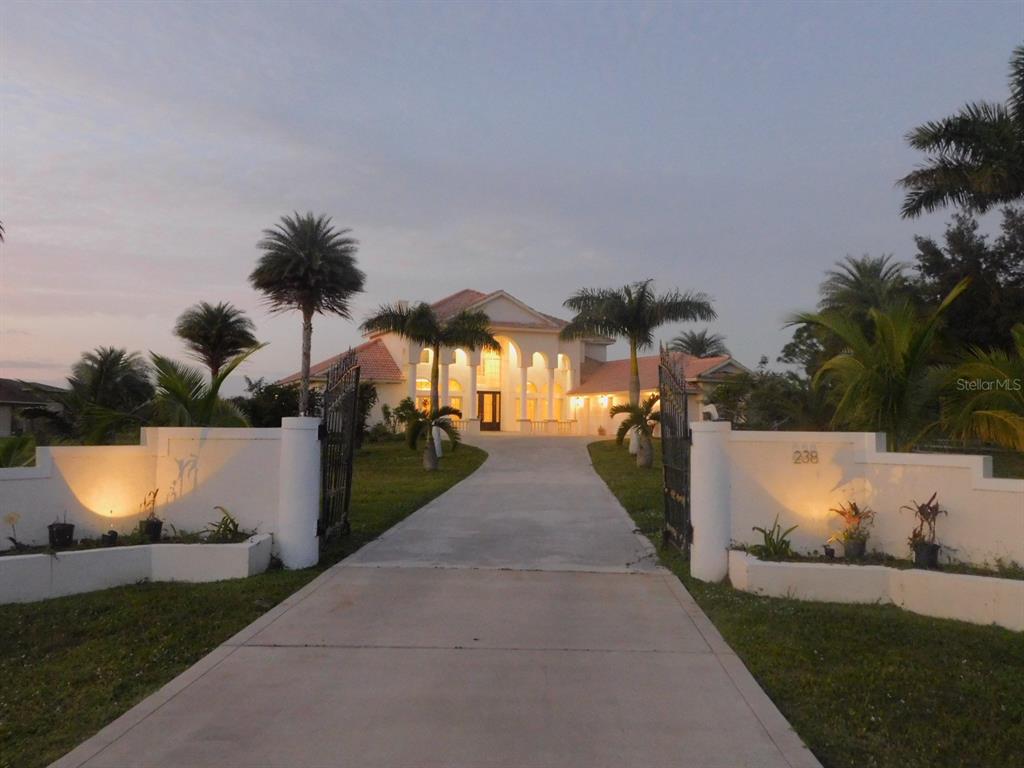 a view of a house with backyard and sitting area