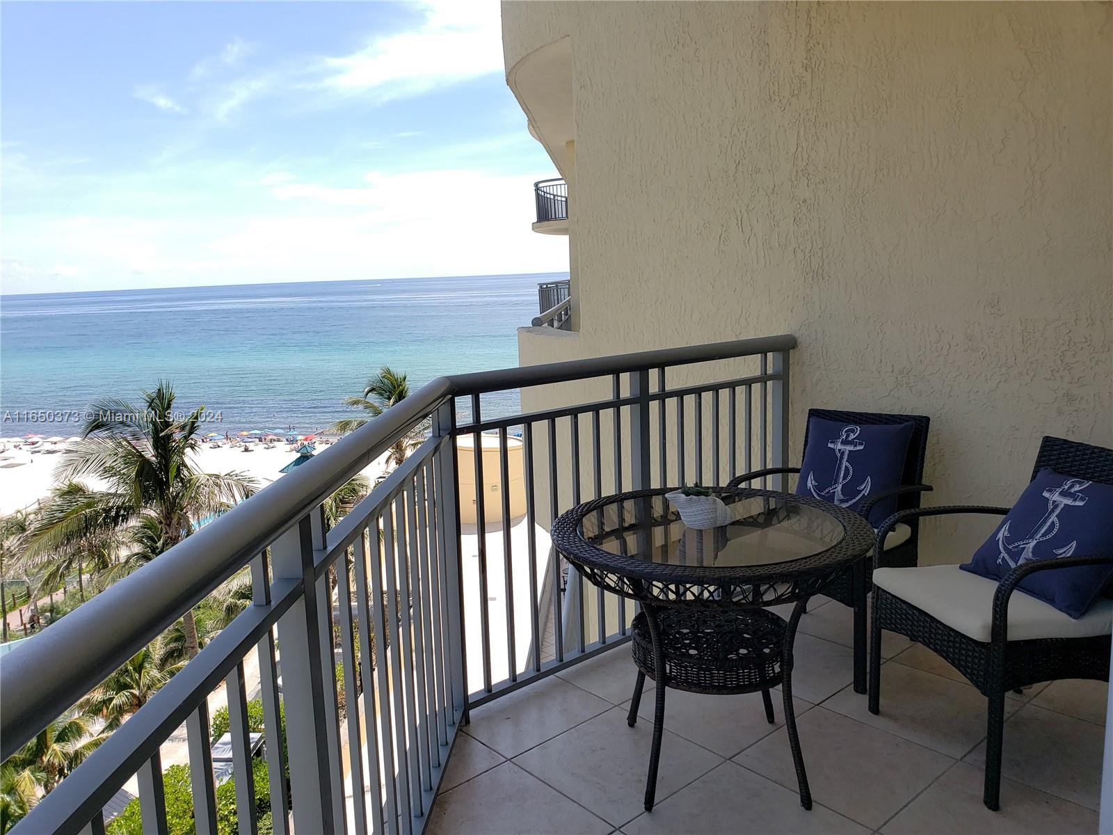 a view of a balcony with furniture