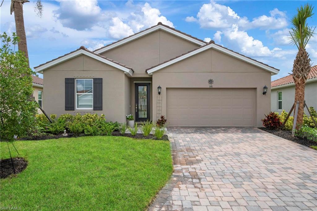 Ranch-style home with a garage and a front lawn