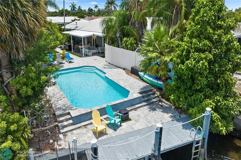 an aerial view of a house with outdoor space patio and furniture