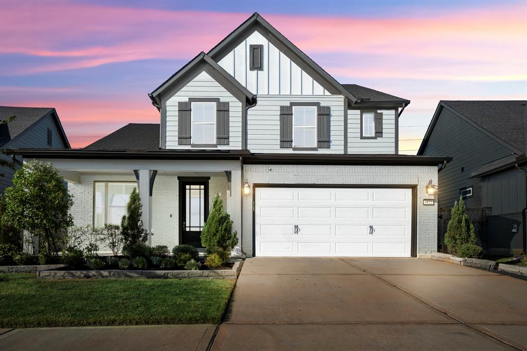 Sensational curb appeal with lush landscaping and painted brick welcomes you to your home! You're greeted by an elegant exterior with white contrasting dark trim, iron lanterns, and a 2 car garage.