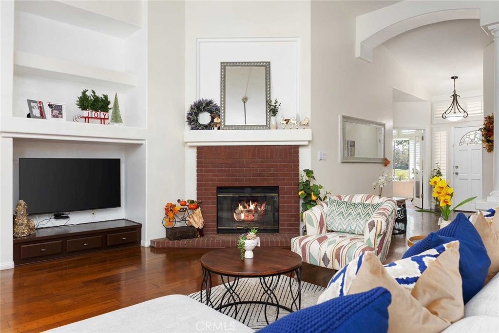 a living room with furniture a fireplace and a flat screen tv