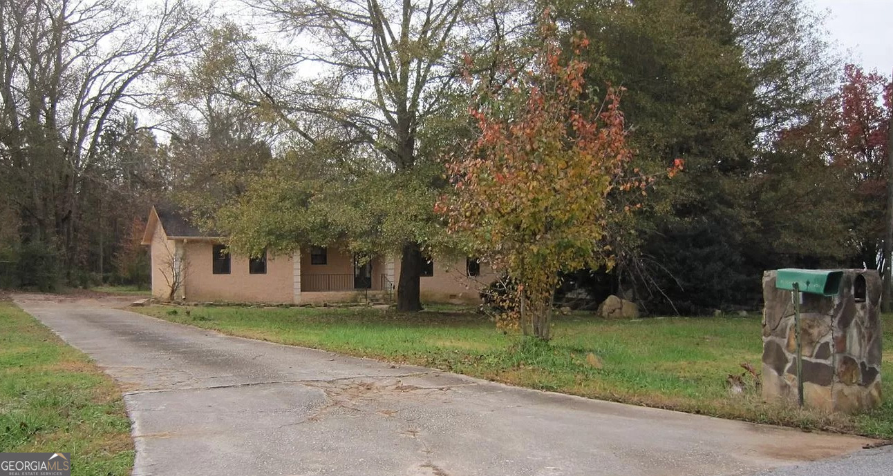 a front view of house with yard and green space