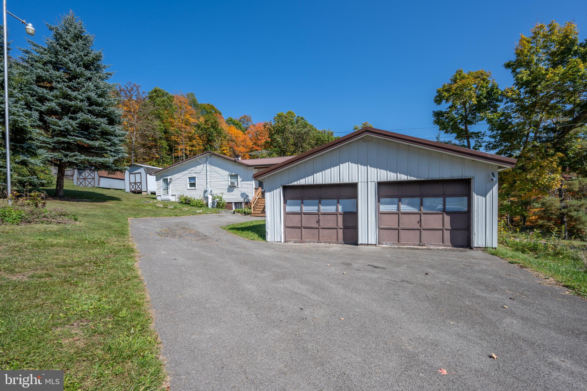 a view of a house with a yard and garage