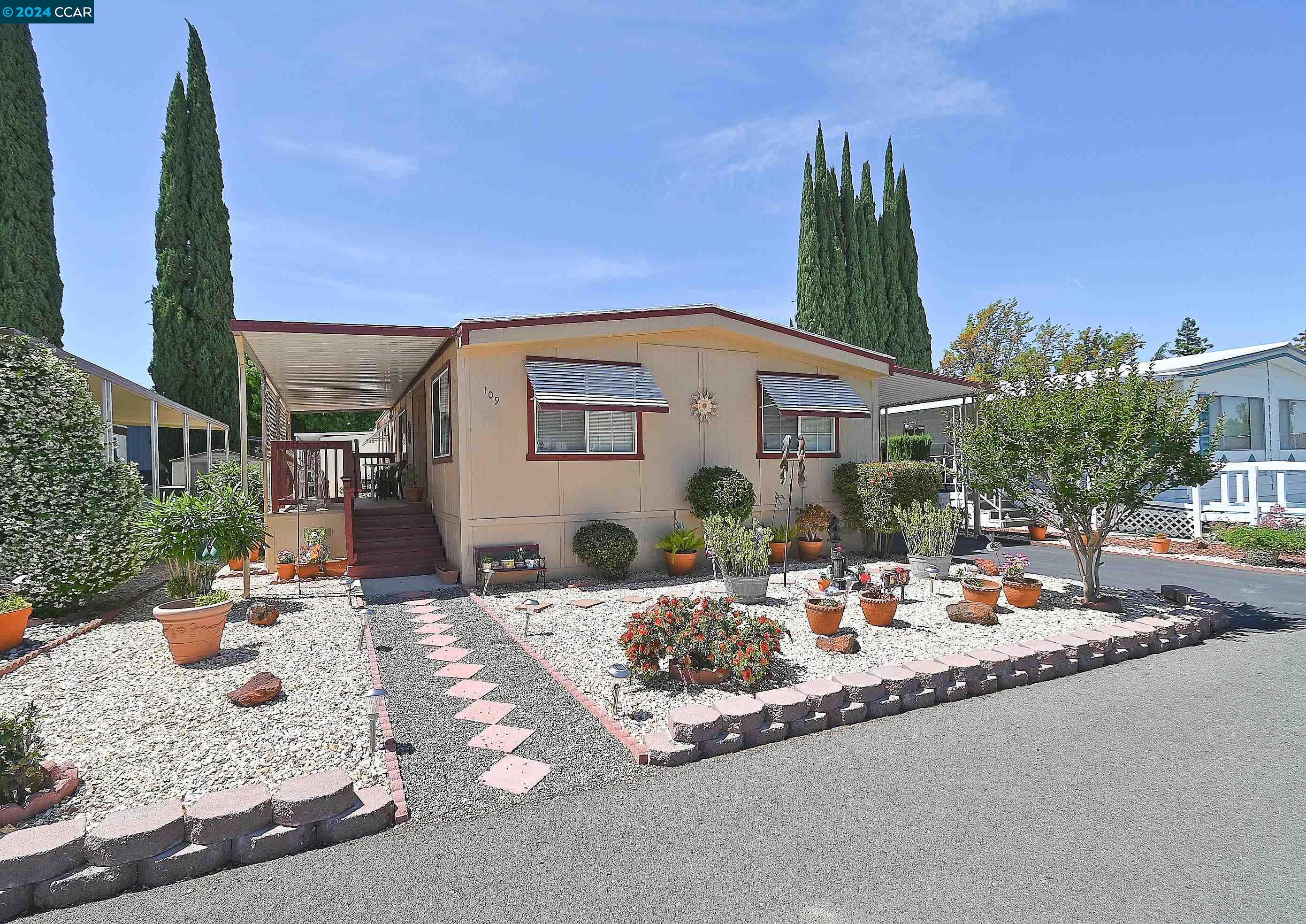 a view of a house with backyard water fountain and sitting area