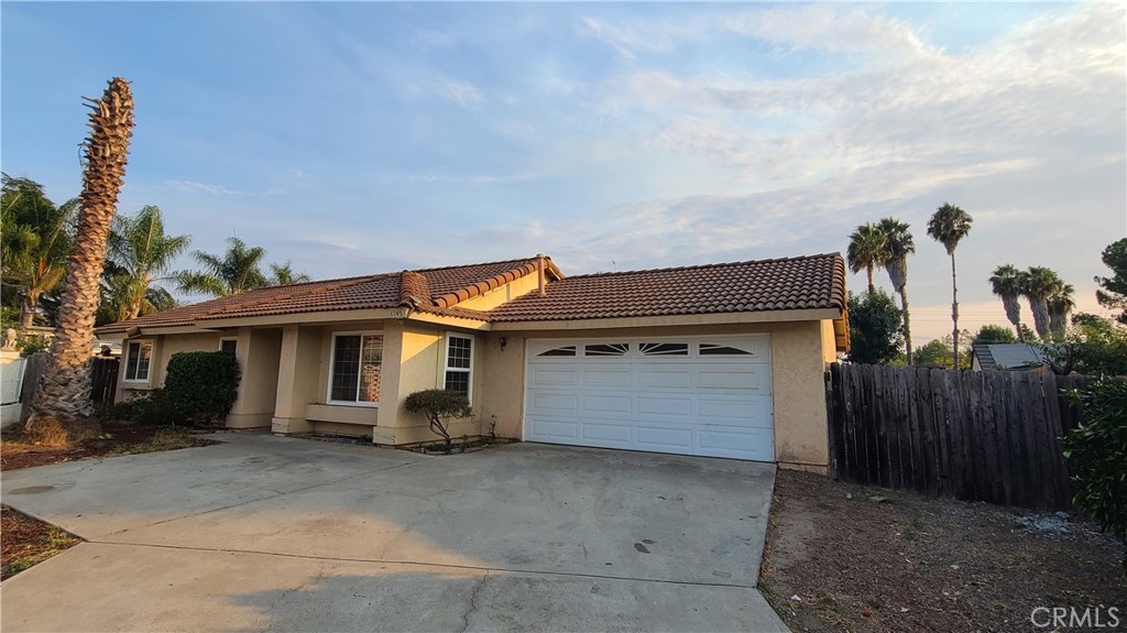 a view of a house with a backyard and garage