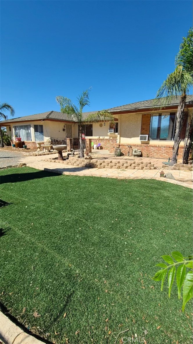 a front view of a house with yard and seating area