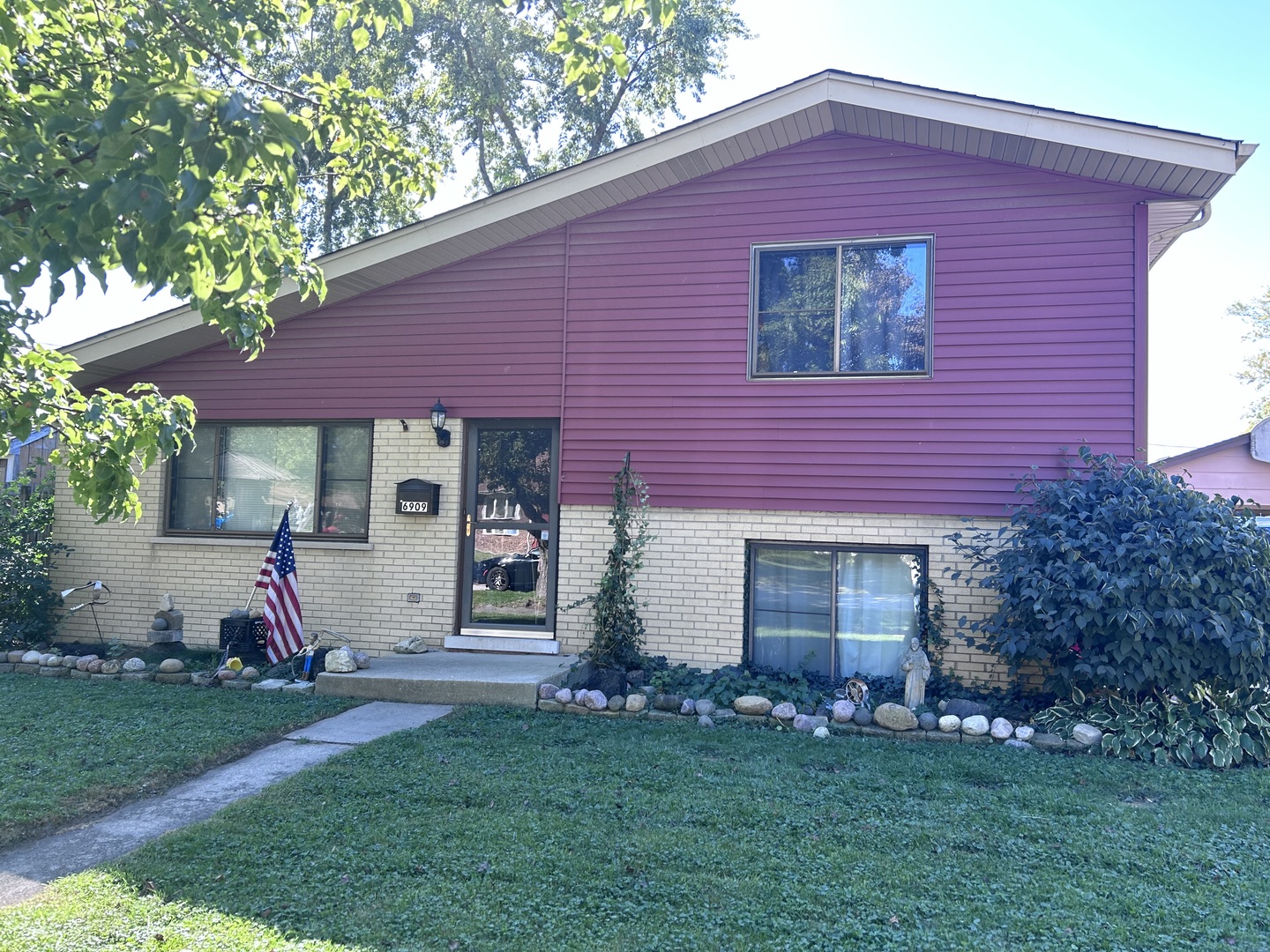 a front view of a house with a garden