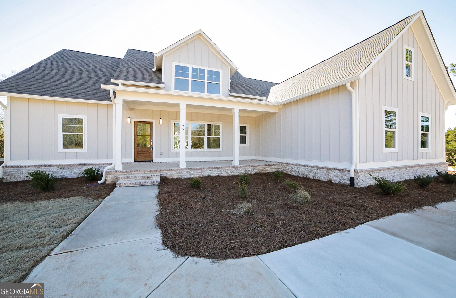 a front view of a house with garden