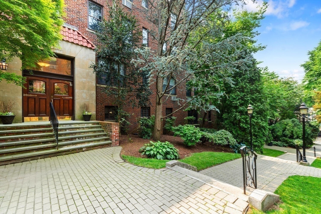 a front view of a house with a garden