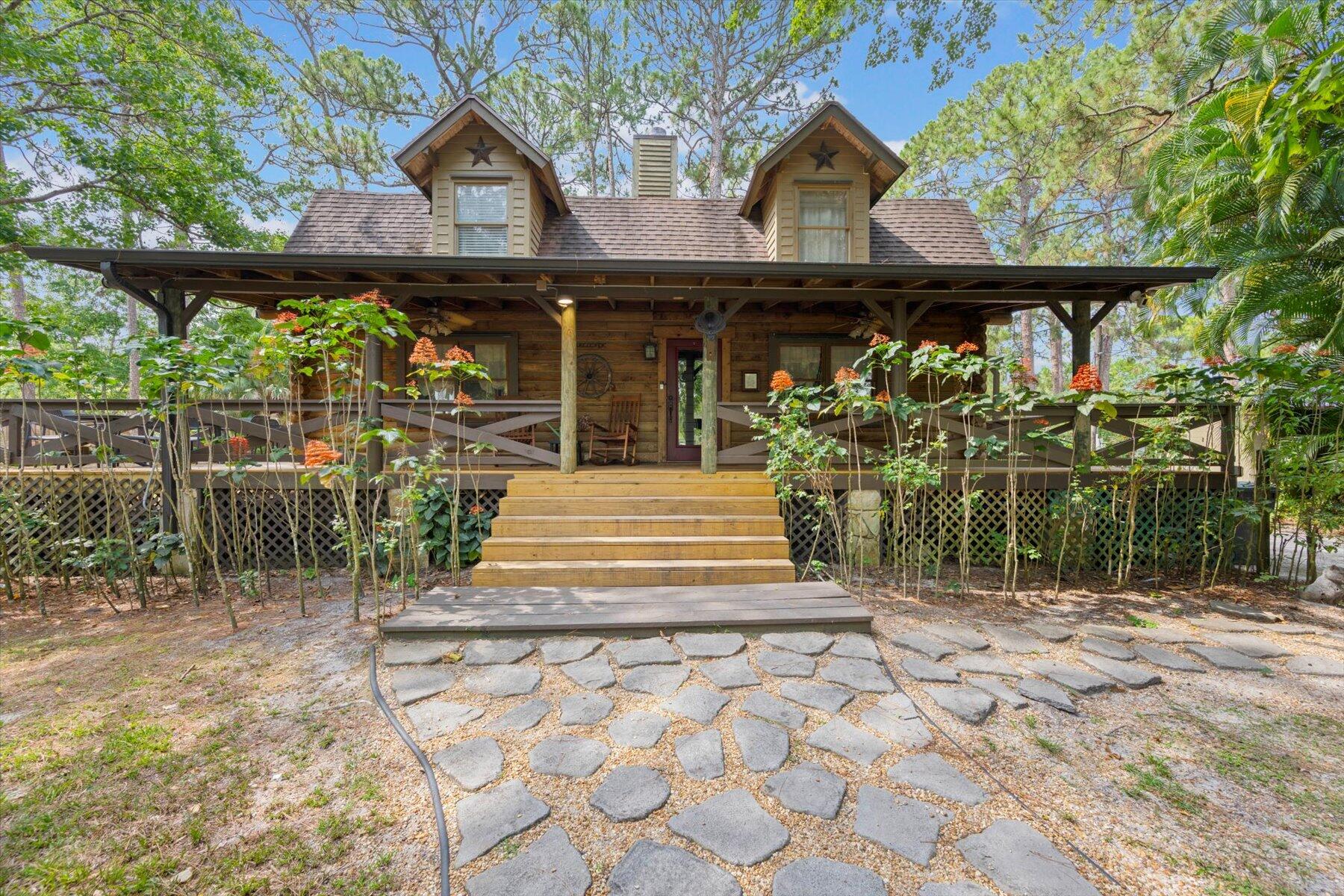 a front view of a house with a garden