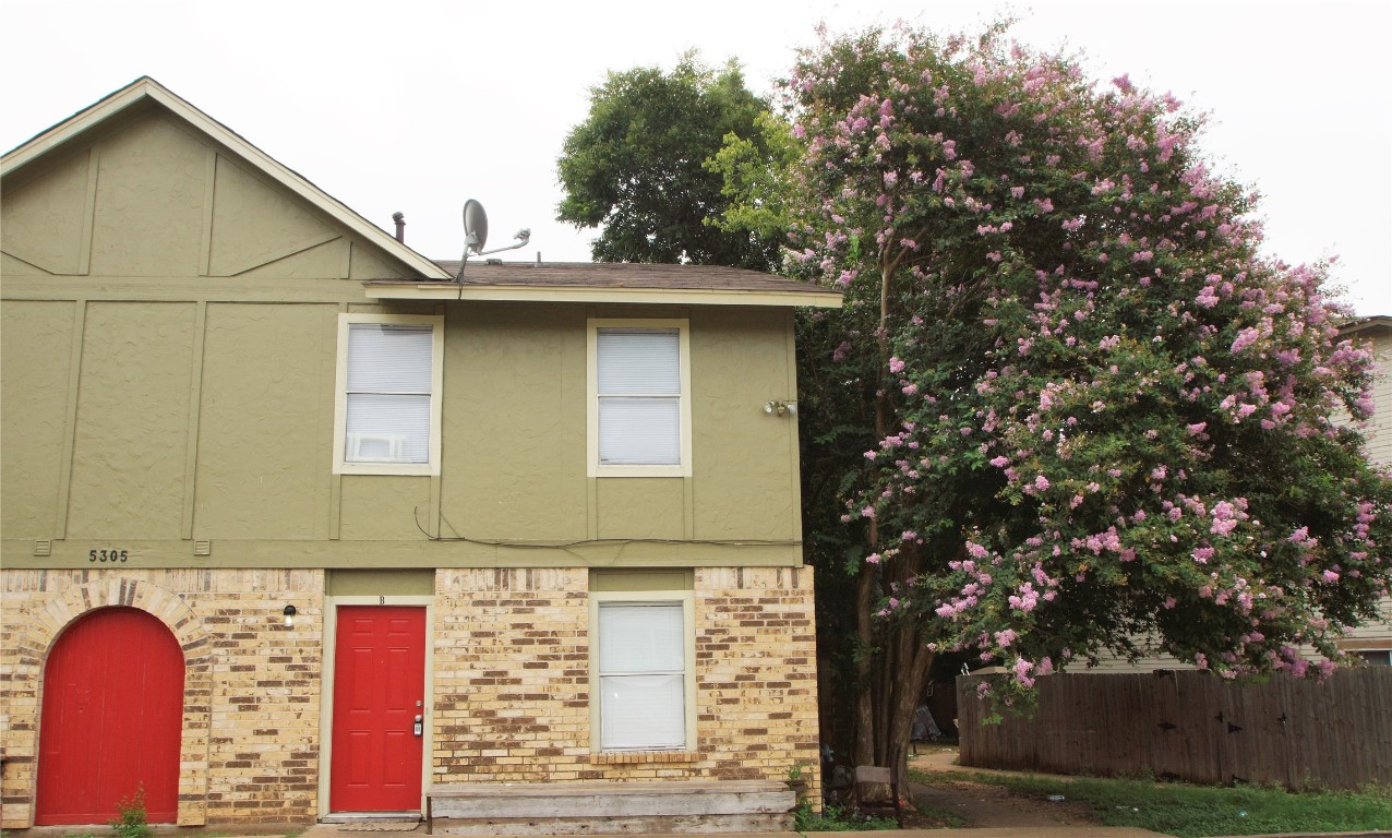 a front view of a house with trees