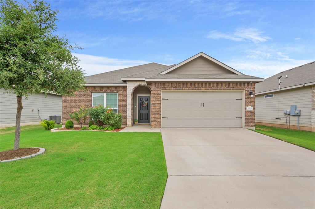 a view of a house with a yard and garage