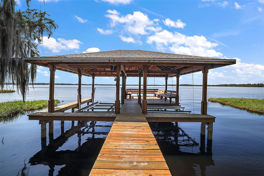 a view of a patio with a table chairs and wooden floor