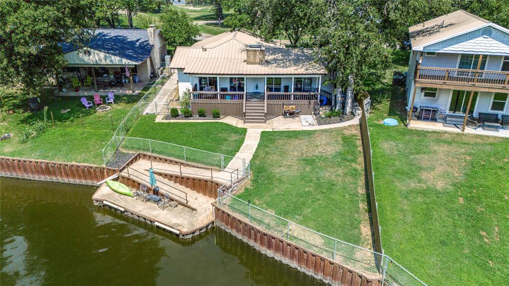 a view of a house with a yard deck and a slide