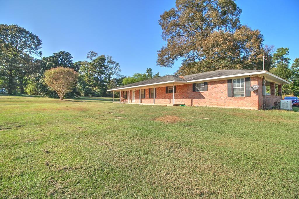 a view of a house with a yard and a garden