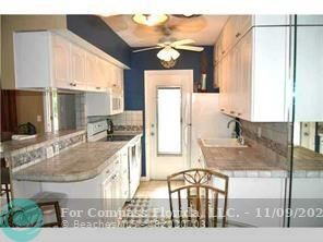 a kitchen with a sink refrigerator and cabinets