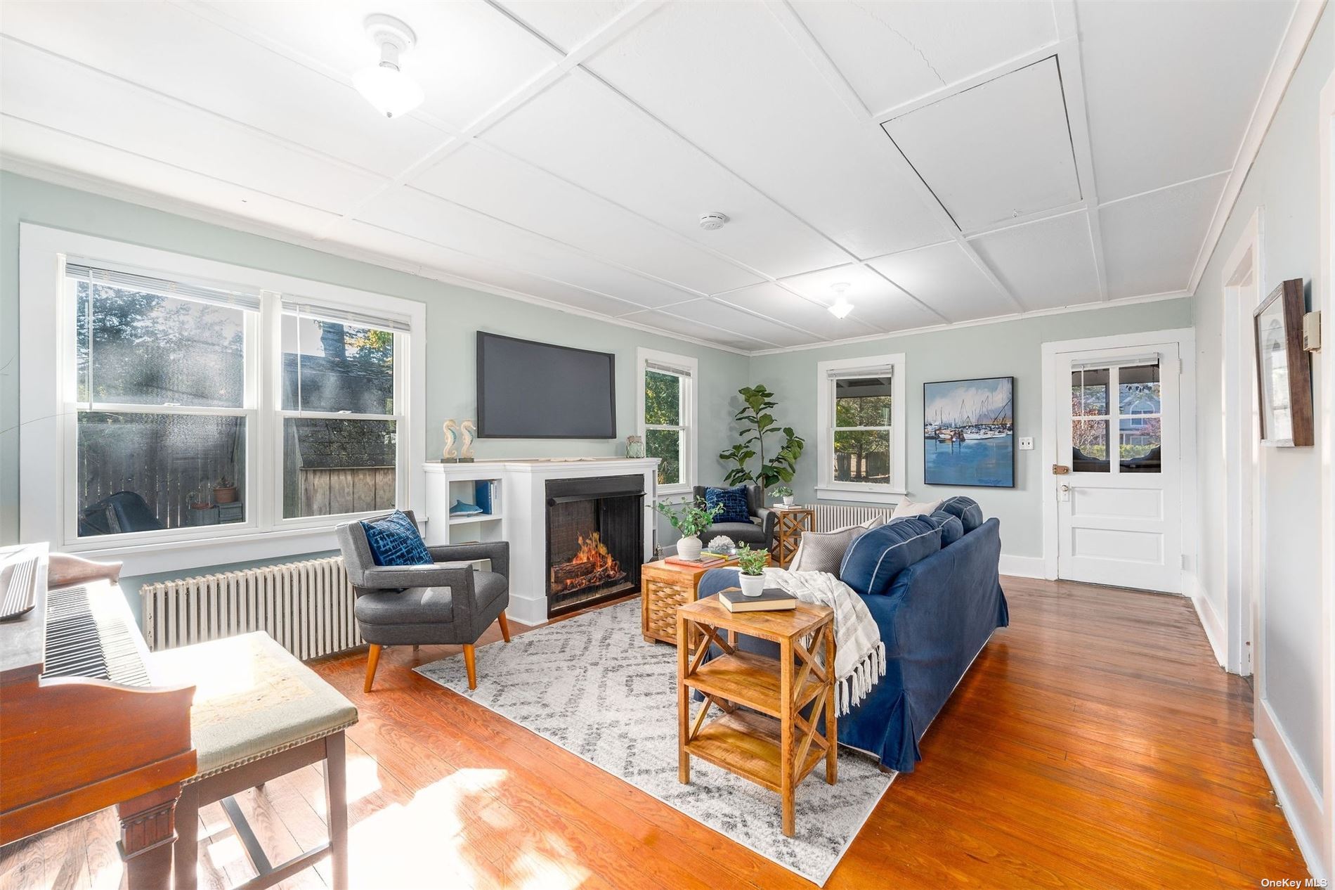 a living room with fireplace furniture and a flat screen tv