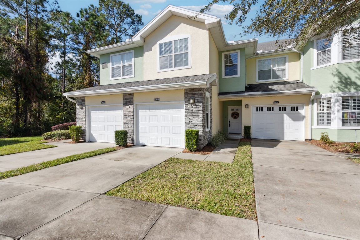 a front view of a house with a yard and garage