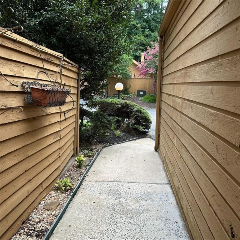 a view of a pathway of a house with a backyard