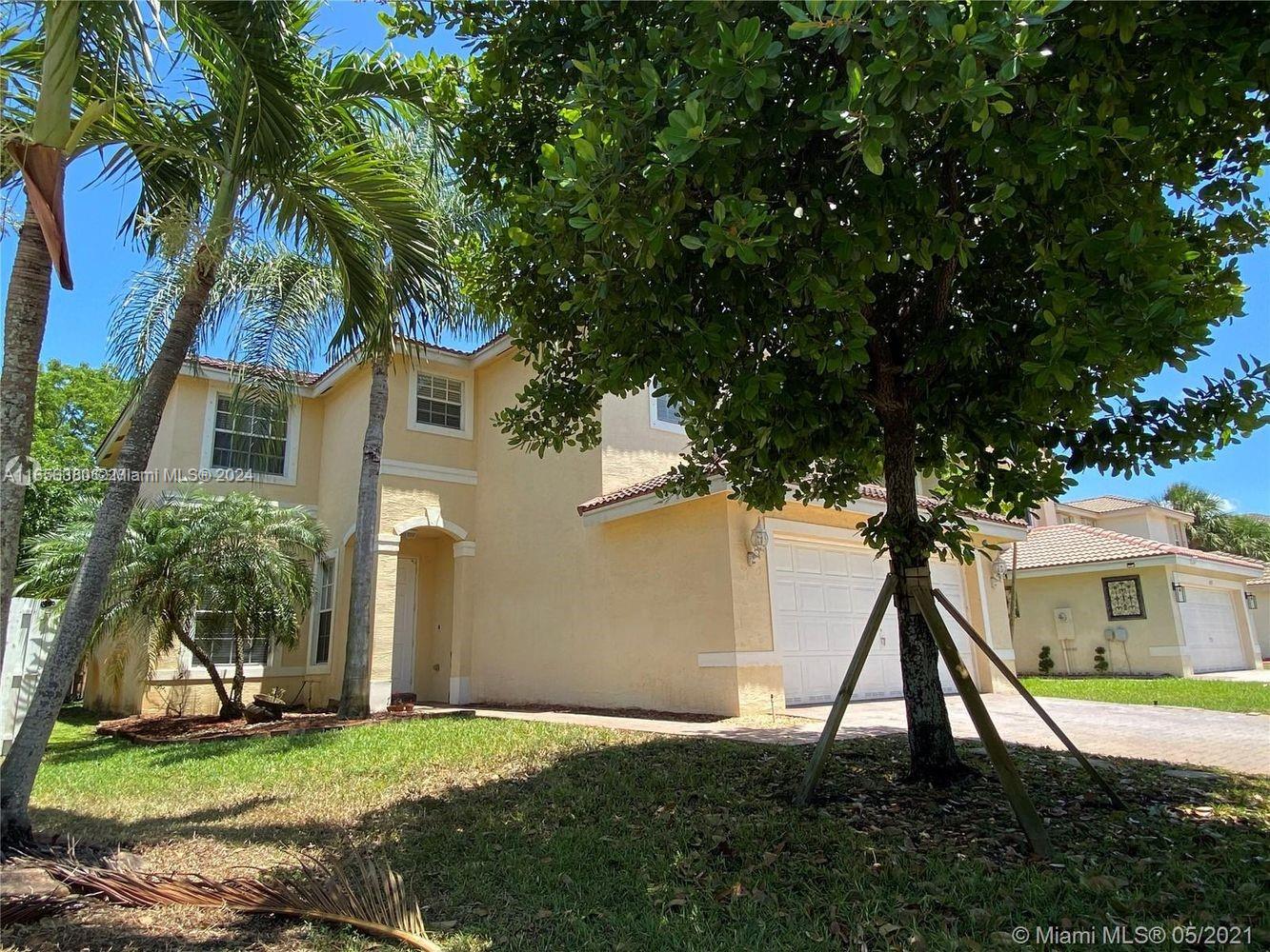 a house that has a tree in front of it