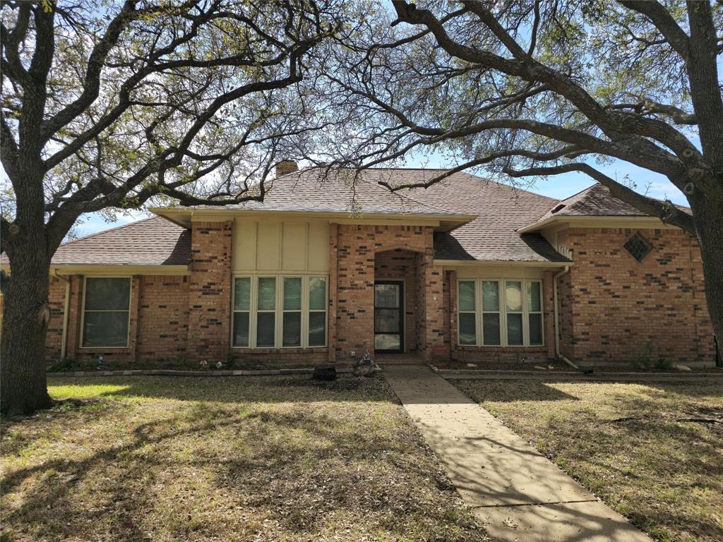 front view of a house with a tree