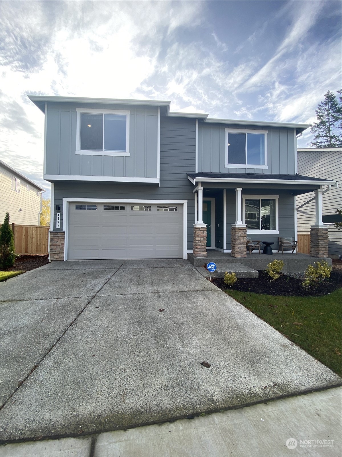 a front view of a house with a yard and garage