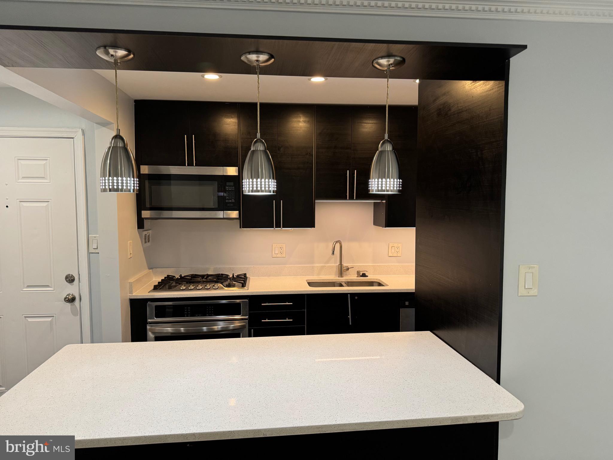 a kitchen with stainless steel appliances a refrigerator and a sink