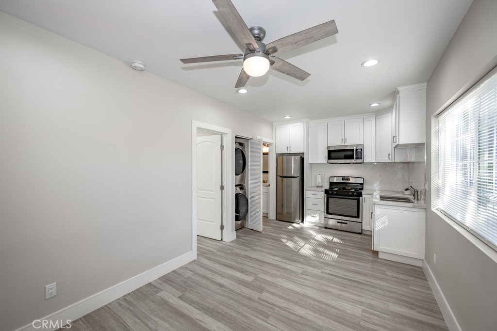 a kitchen with stainless steel appliances a refrigerator and a stove top oven