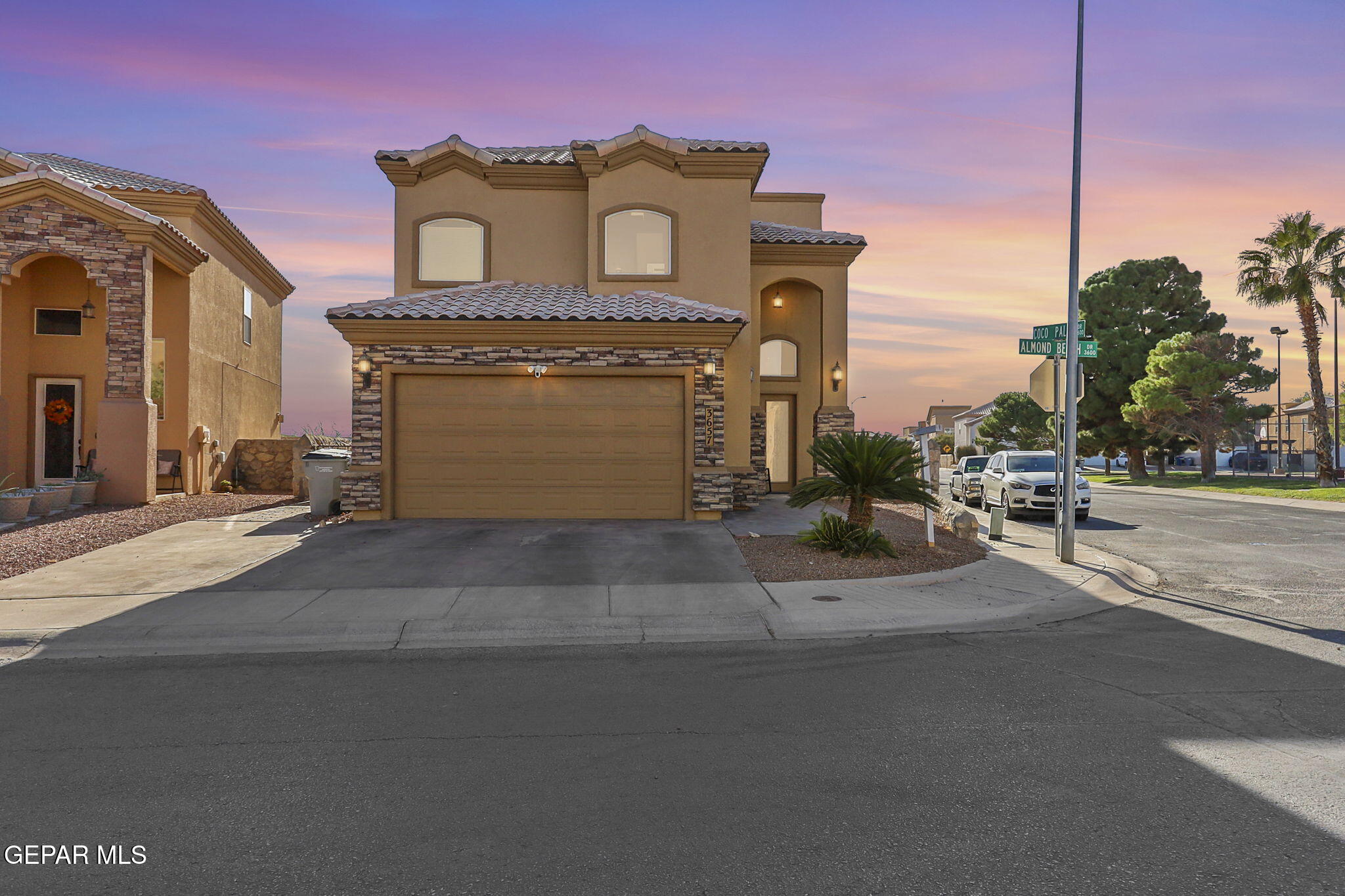 a front view of a house with a street