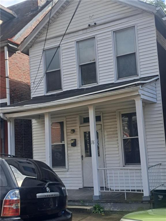 a view of a car parked front of a house