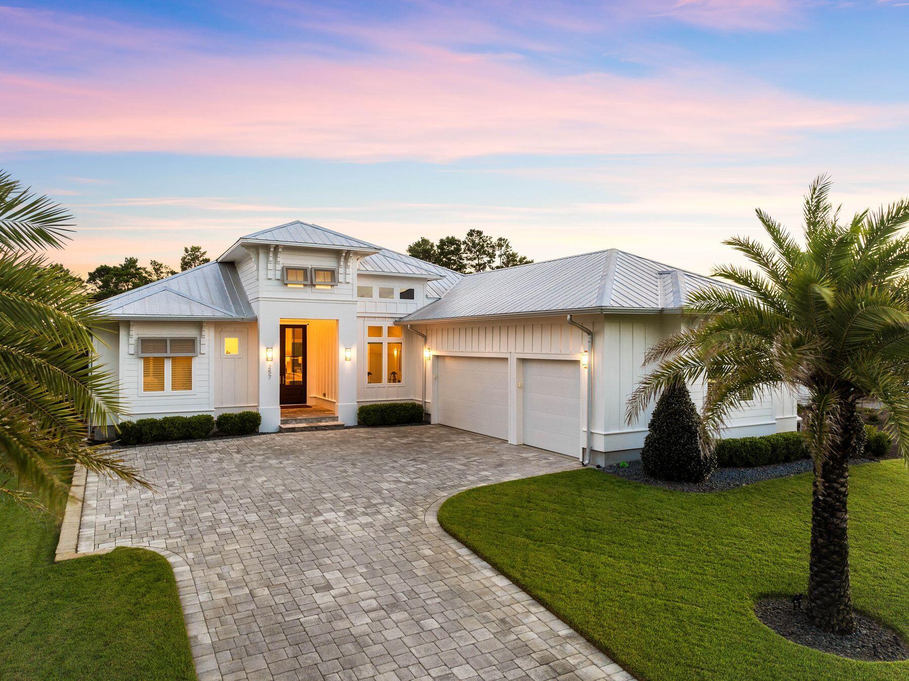 a front view of a house with a garden