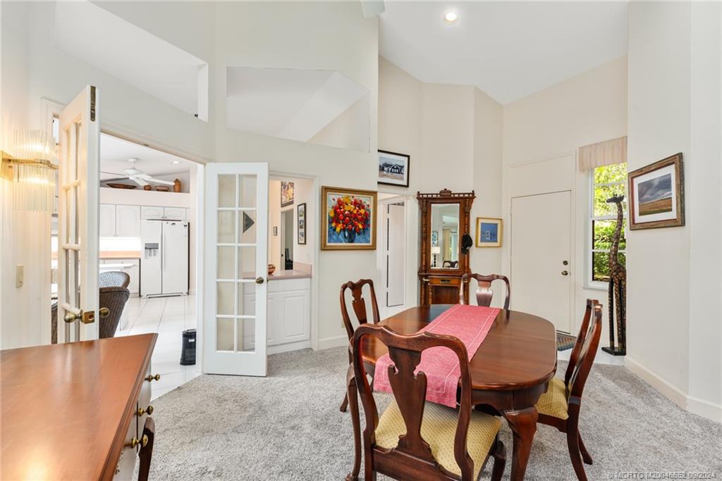 a view of a dining room with furniture and a chandelier