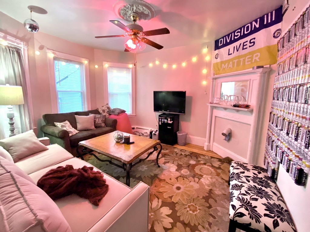 a bedroom with furniture and a flat screen tv