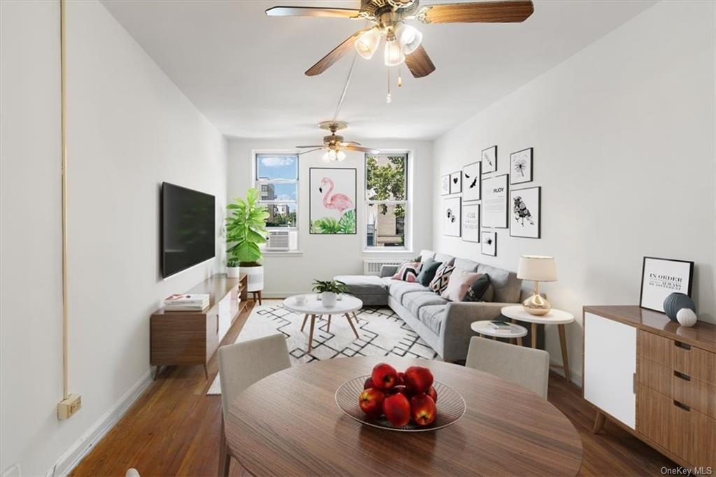 Living room featuring dark hardwood / wood-style flooring and ceiling fan Digital Furniture