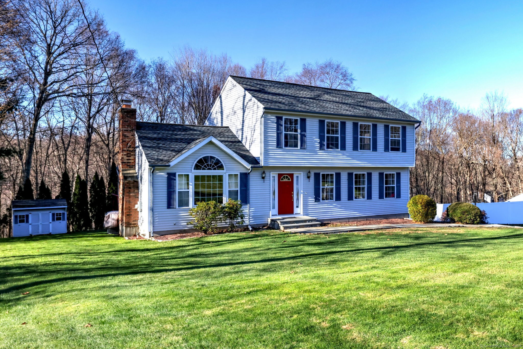 a front view of house with yard and green space